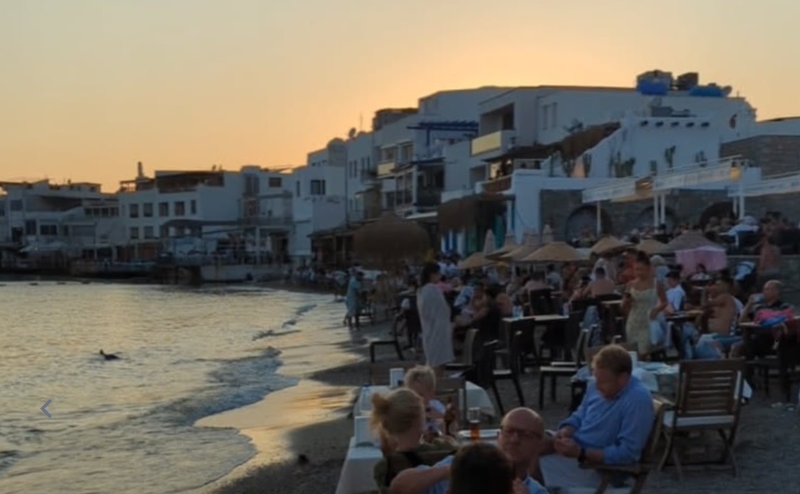 Restaurant tables on the beach up to the water line