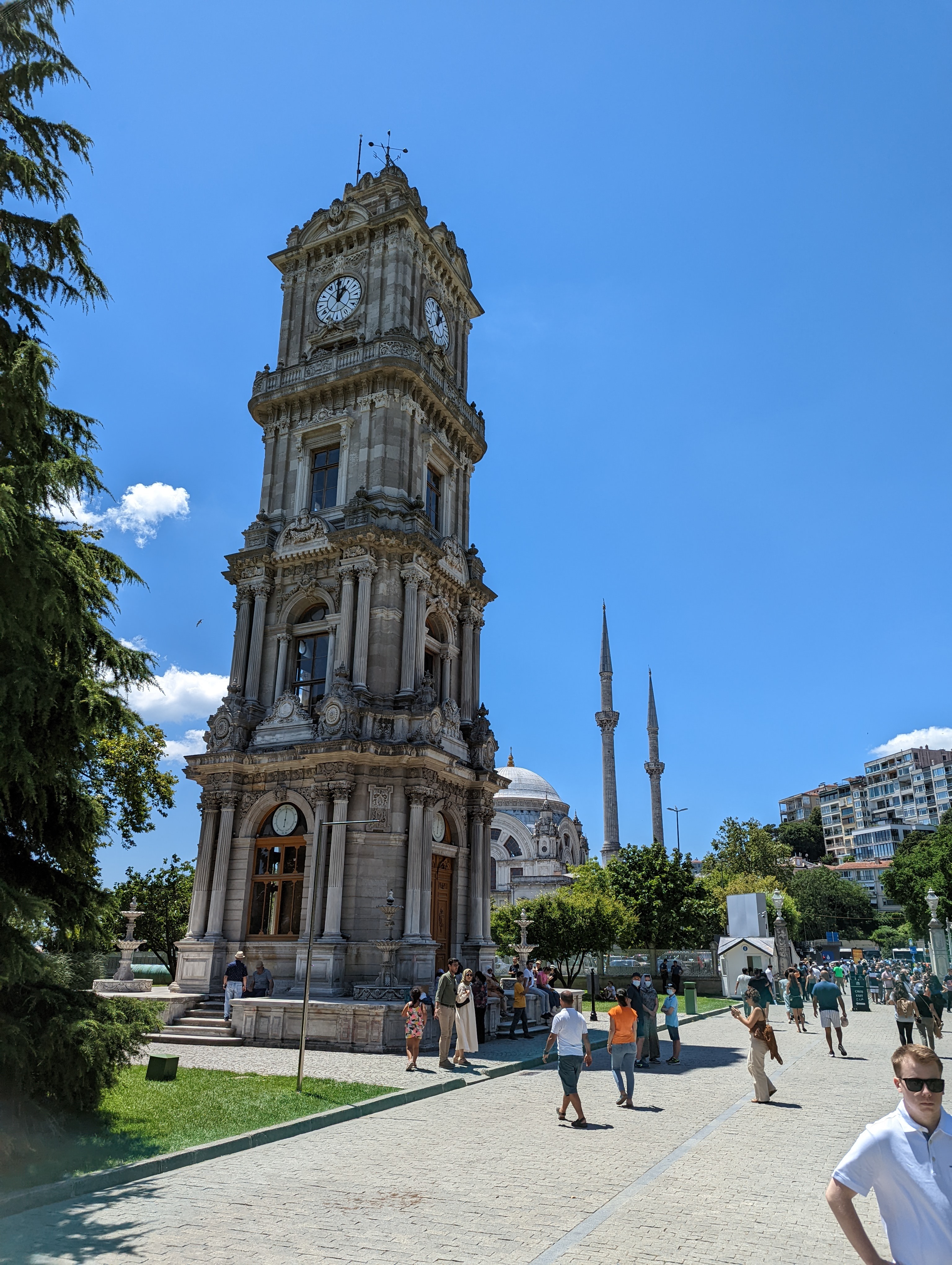 the Dolmabahçe Clock Tower (Dolmabahçe Saat Kulesi), situated between the treasury gate of Dolmabahçe Palace and the Bezmiâlem Valide Sultan Mosque along the Bosphorus waterfront in Istanbul.