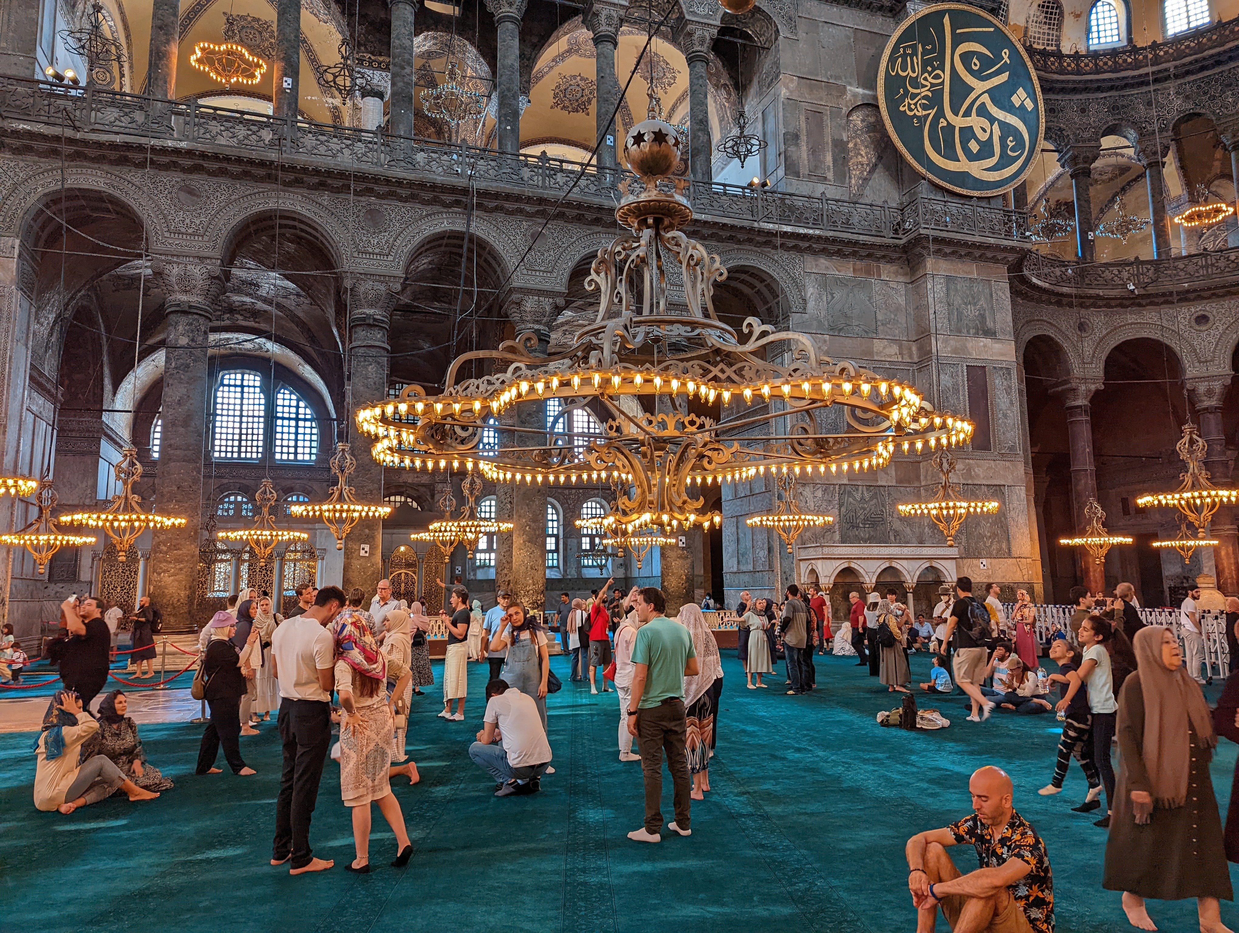 The many beautiful chandeliers hanging down on chains from above.