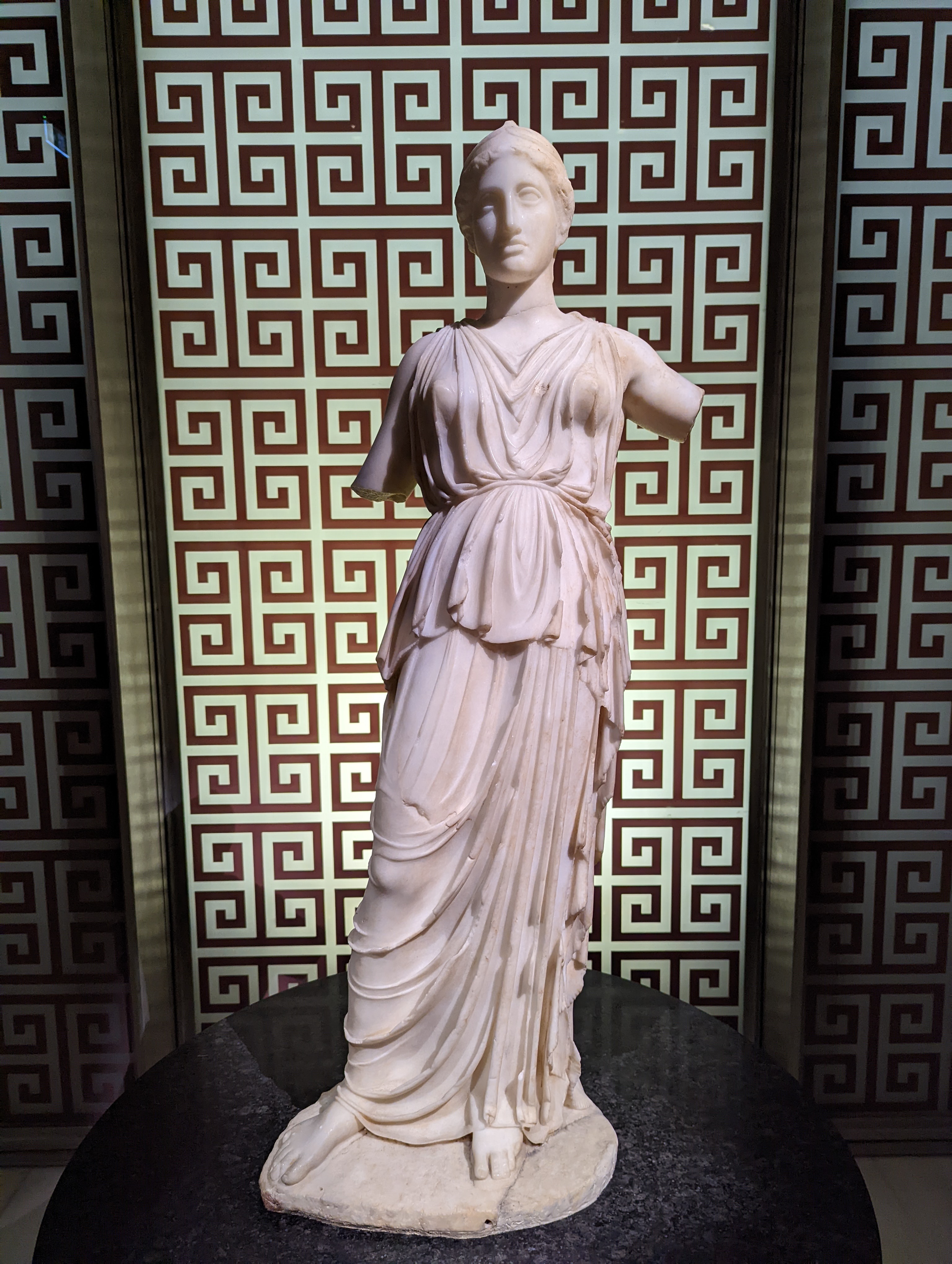 A Hellenistic-style Marble Statue of a Draped Woman (often identified as a Muse, Nymph, or Aphrodite / Artemis type)