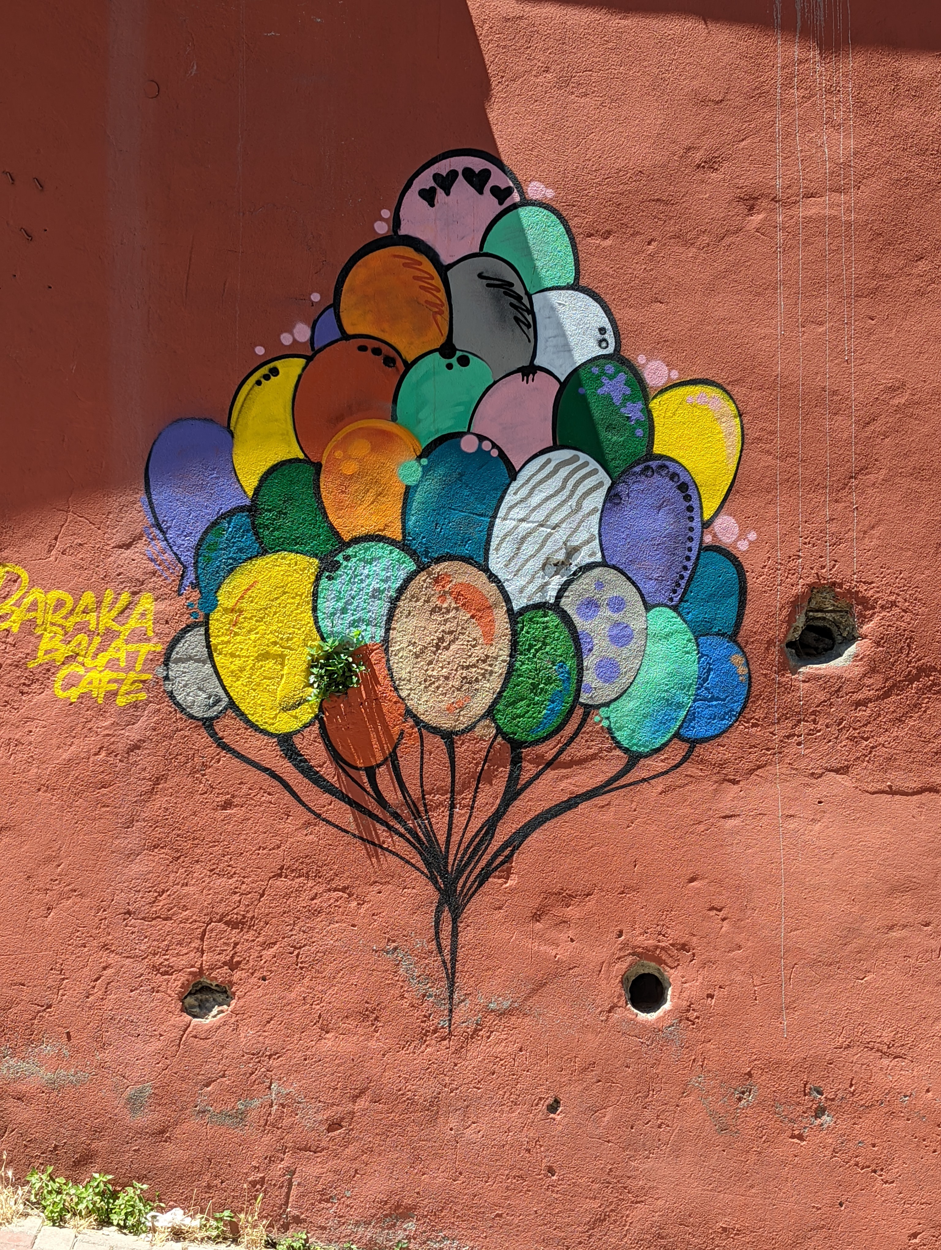 Street art featuring some colorful balloons in Istanbul's Balat neighborhood.
