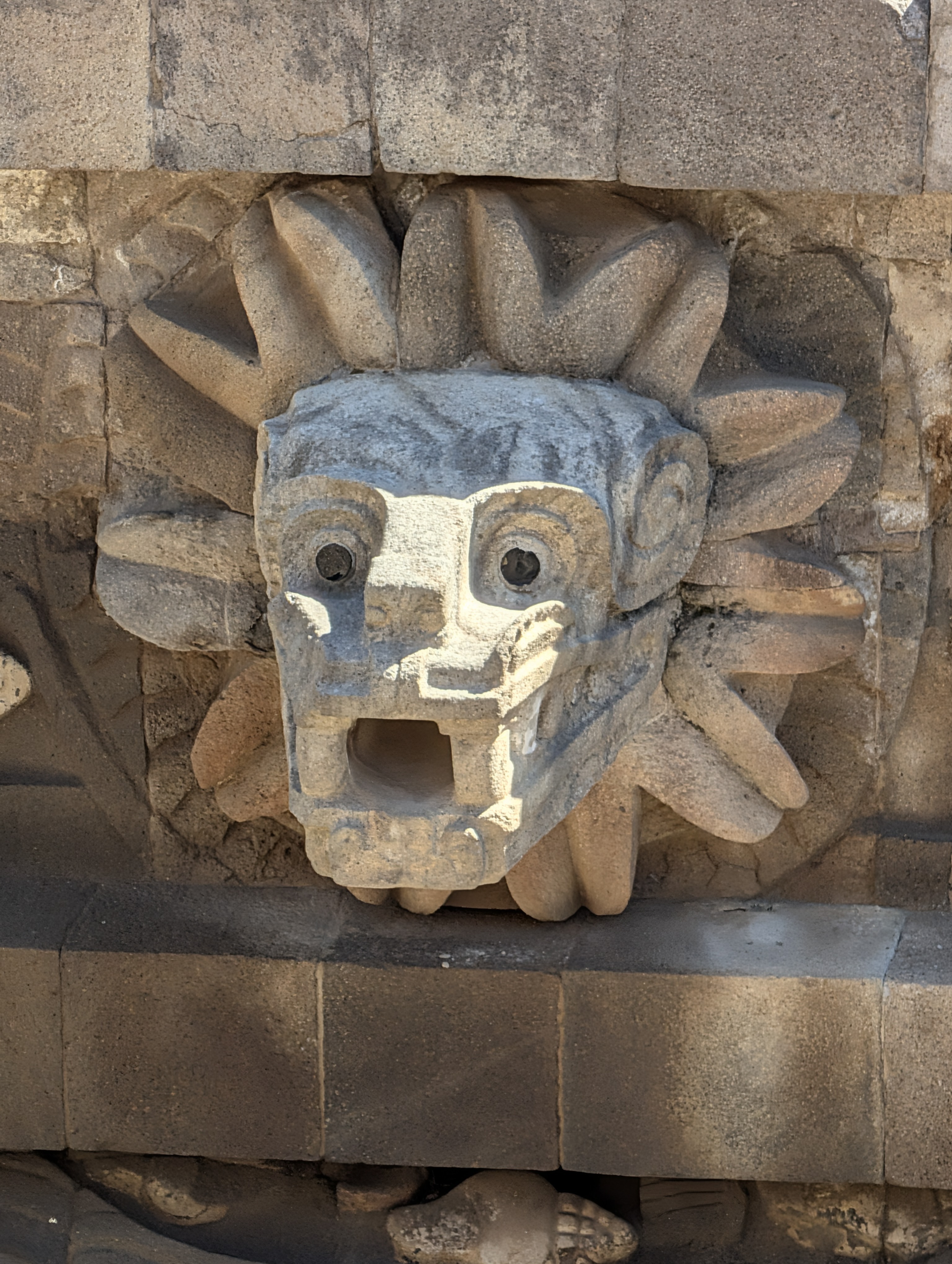 One of the carved Feathered Serpent / Cipactli (Great Crocodile) heads jutting from the façade of the Temple of the Feathered Serpent at the Ciudadela