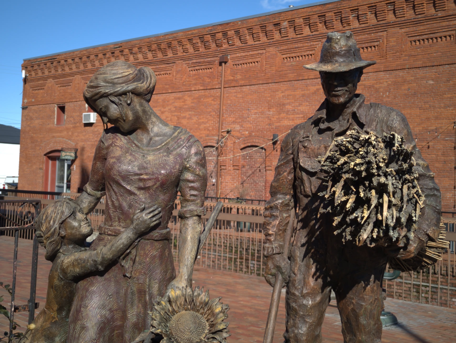 Metal sculpture of farming family