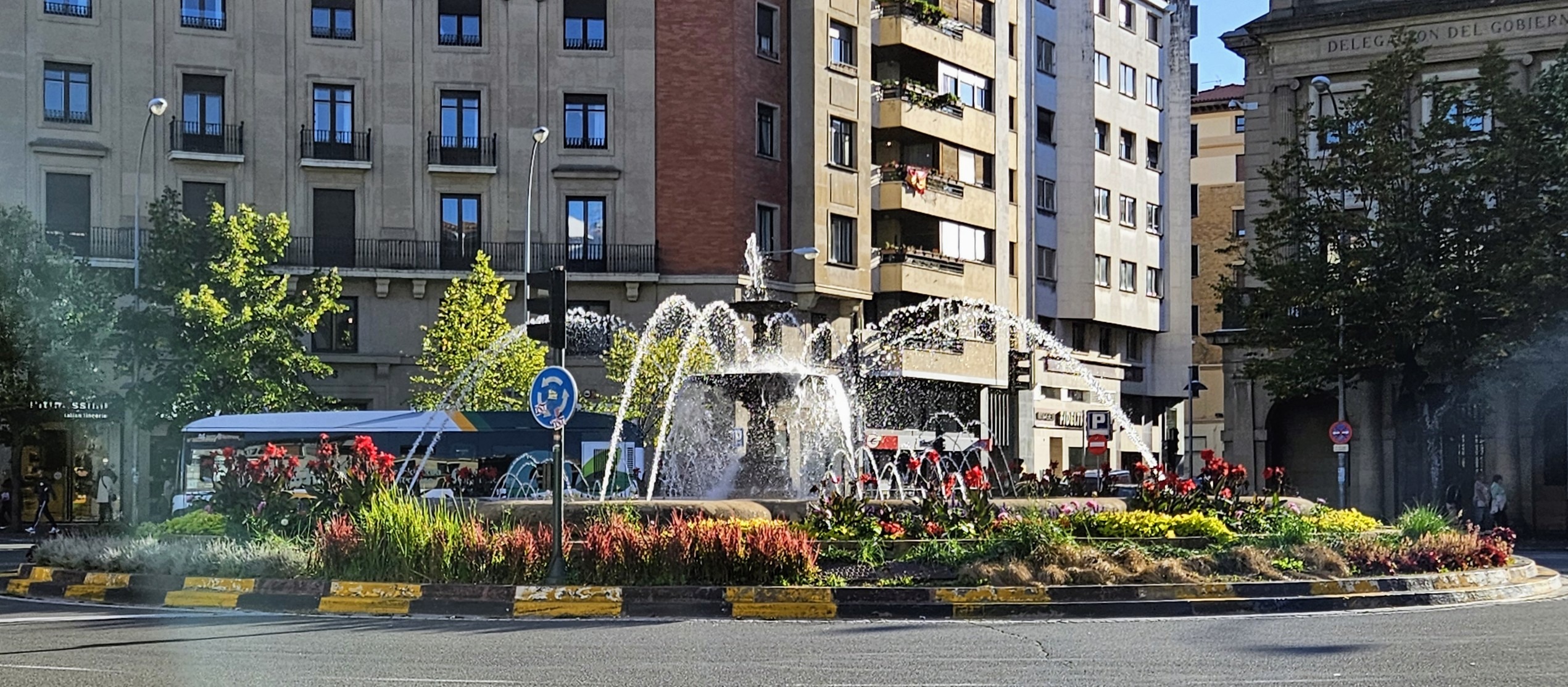 Las Merindades roundabout with fountain and flowerbeds.