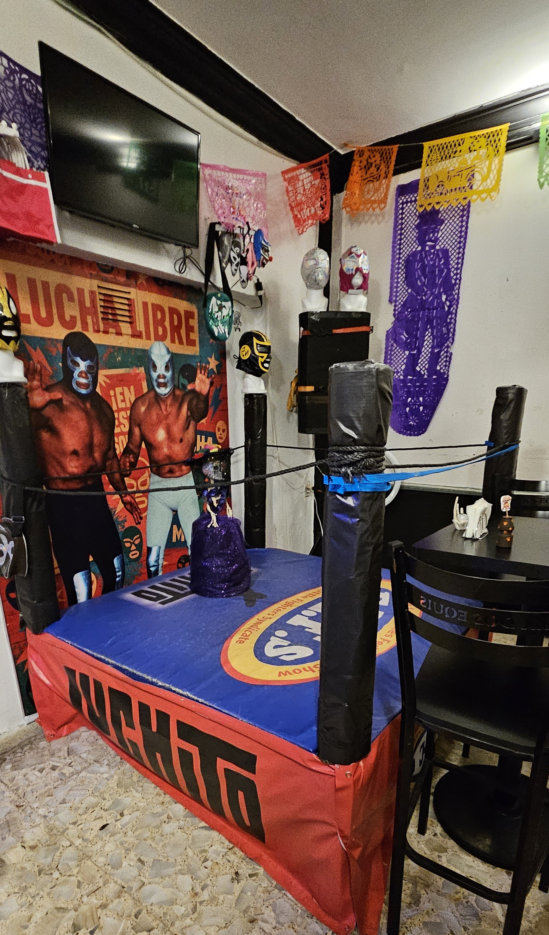 Mini lucha libre ring in the corner of a bar