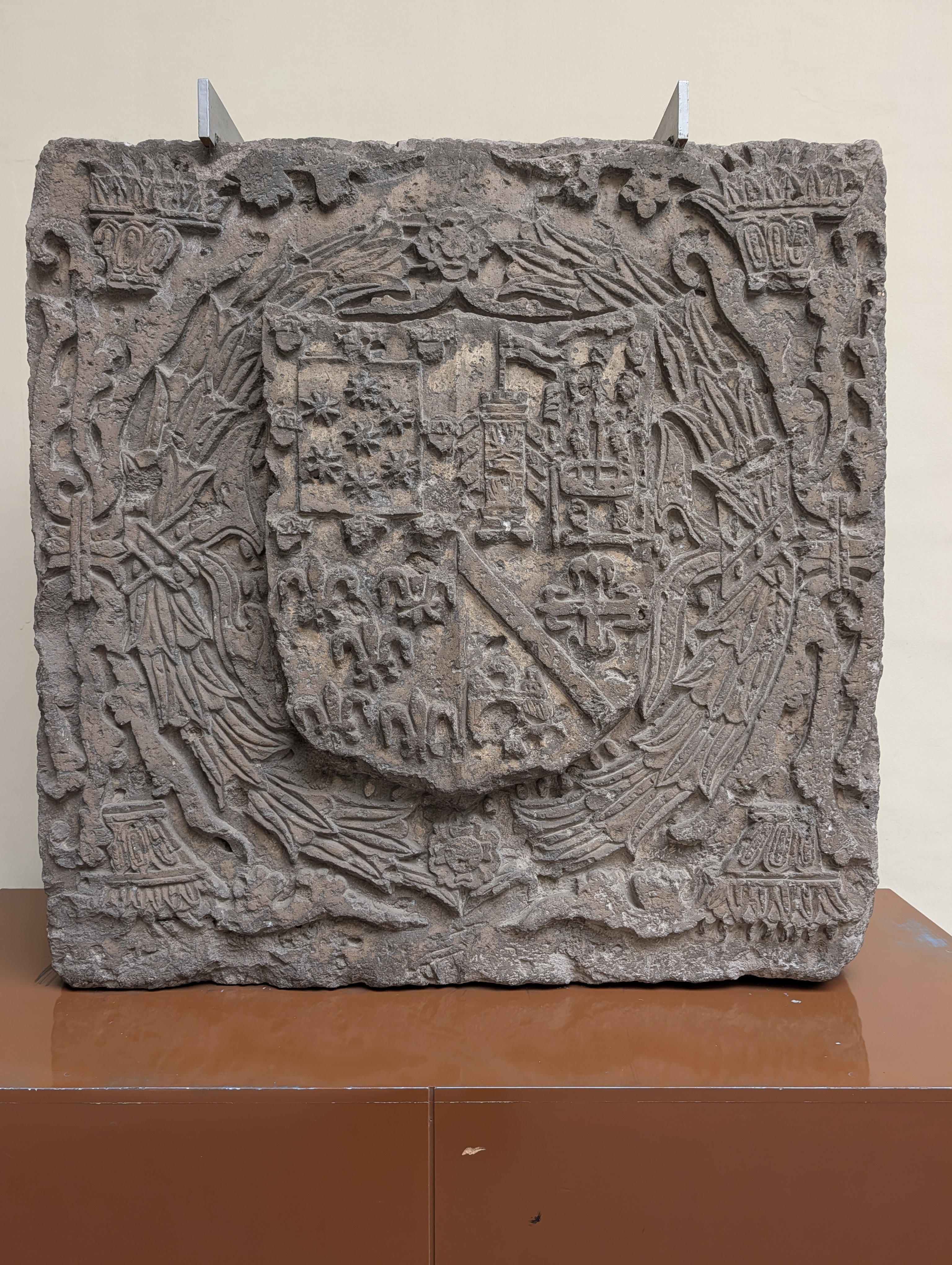 A carved stone heraldic coat-of-arms shield (escudo) from the Spanish colonial period