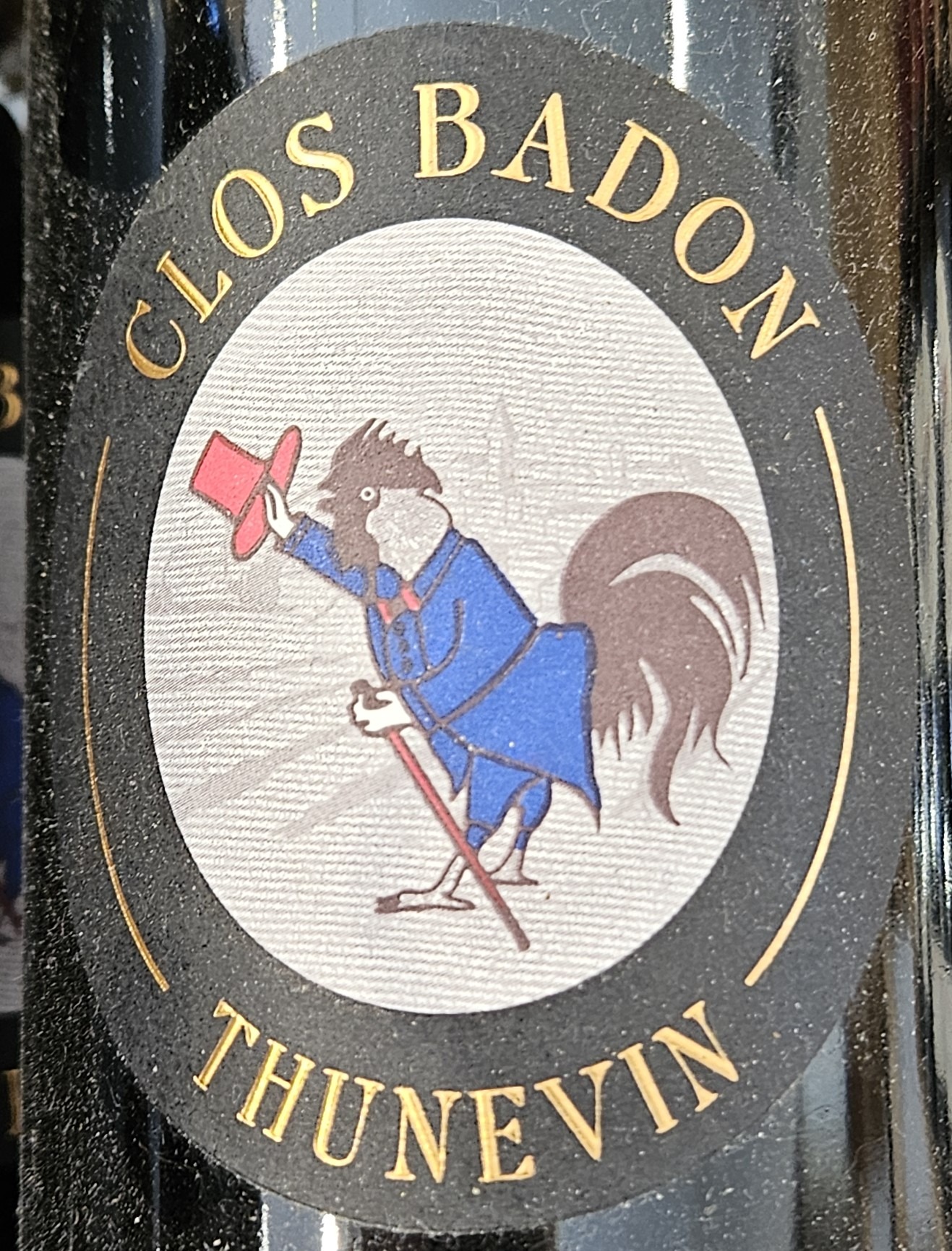 Wine label with rooster tipping his top hat