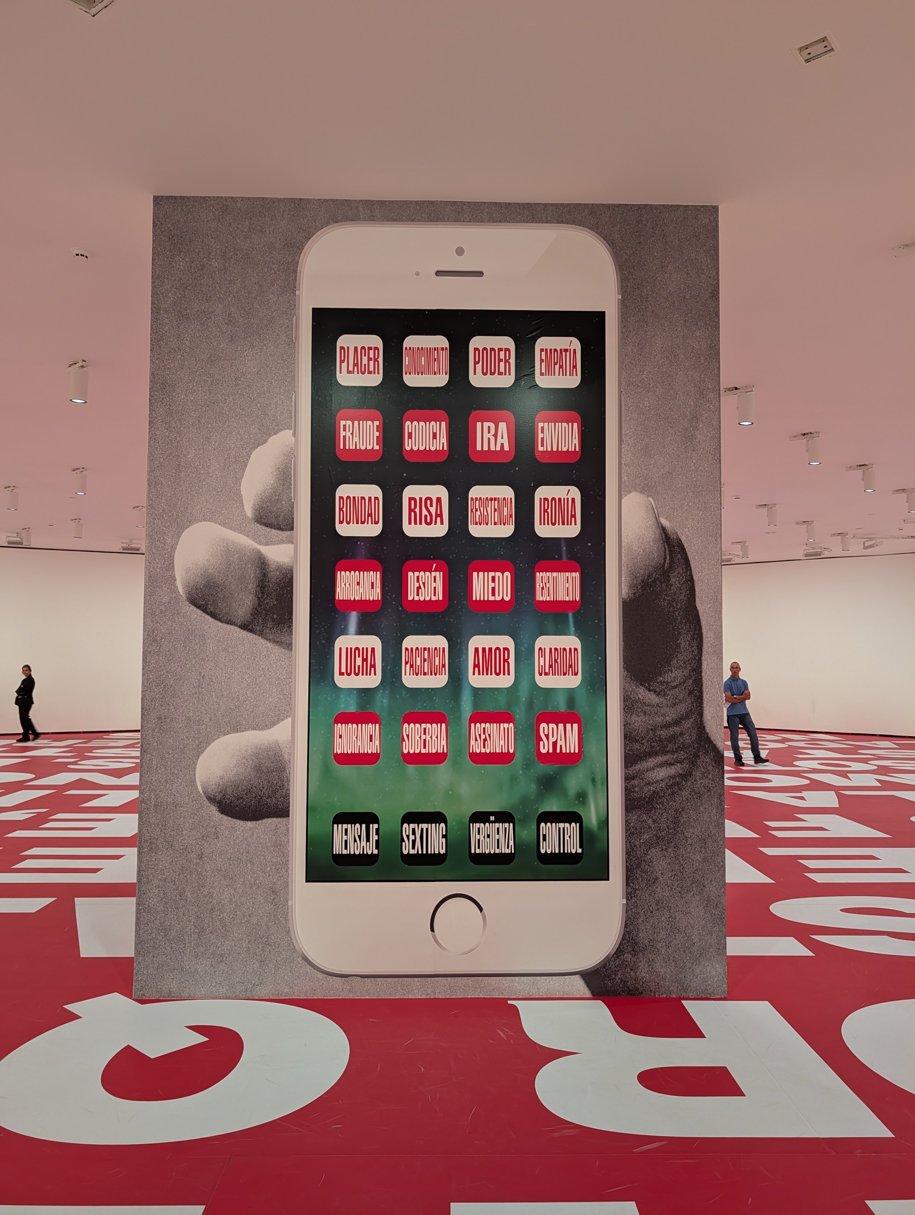 Image from Barbara Kruger exhibit, cell phone with words on icons