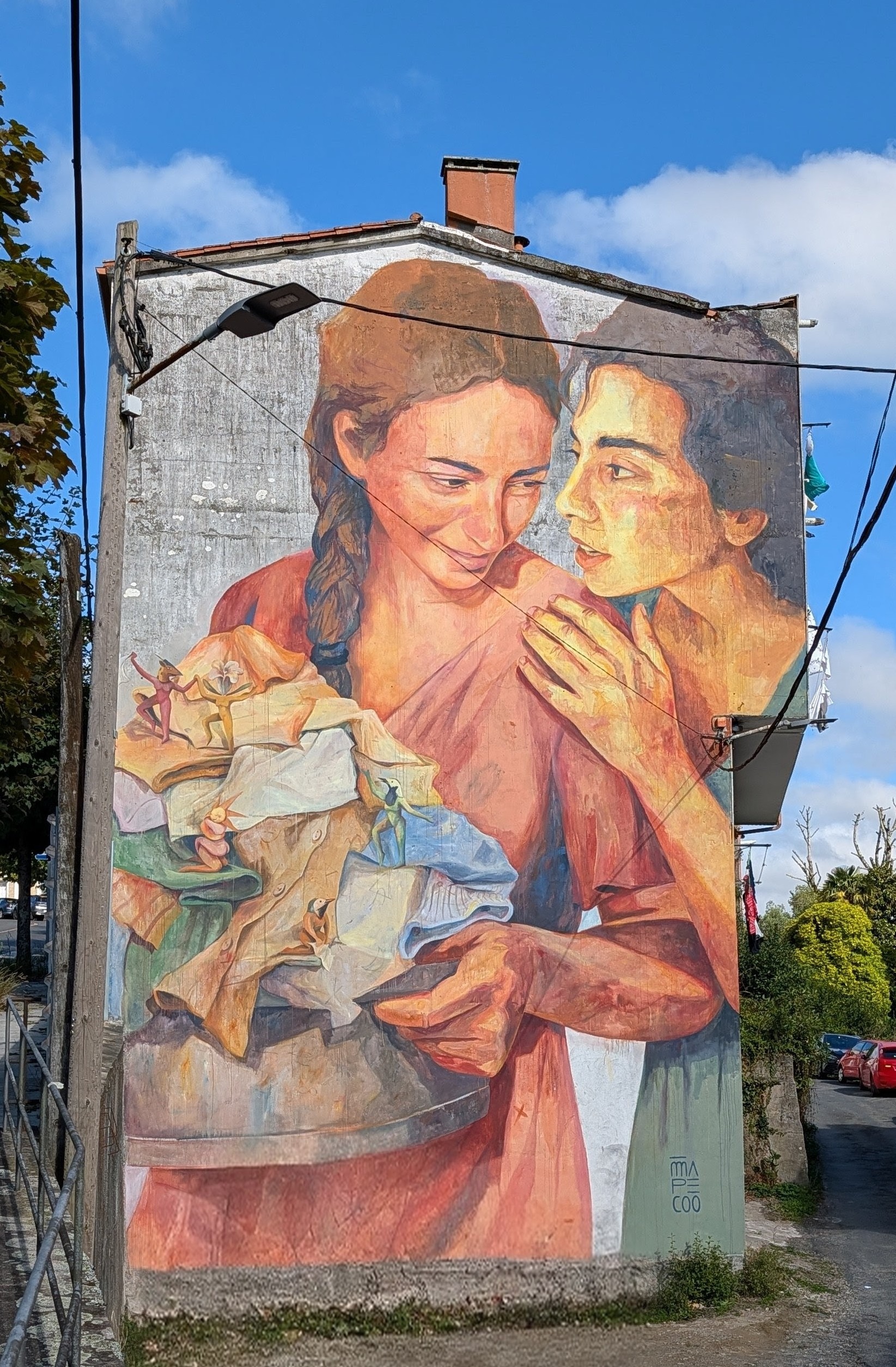 Mural with ladies and pile of laundry