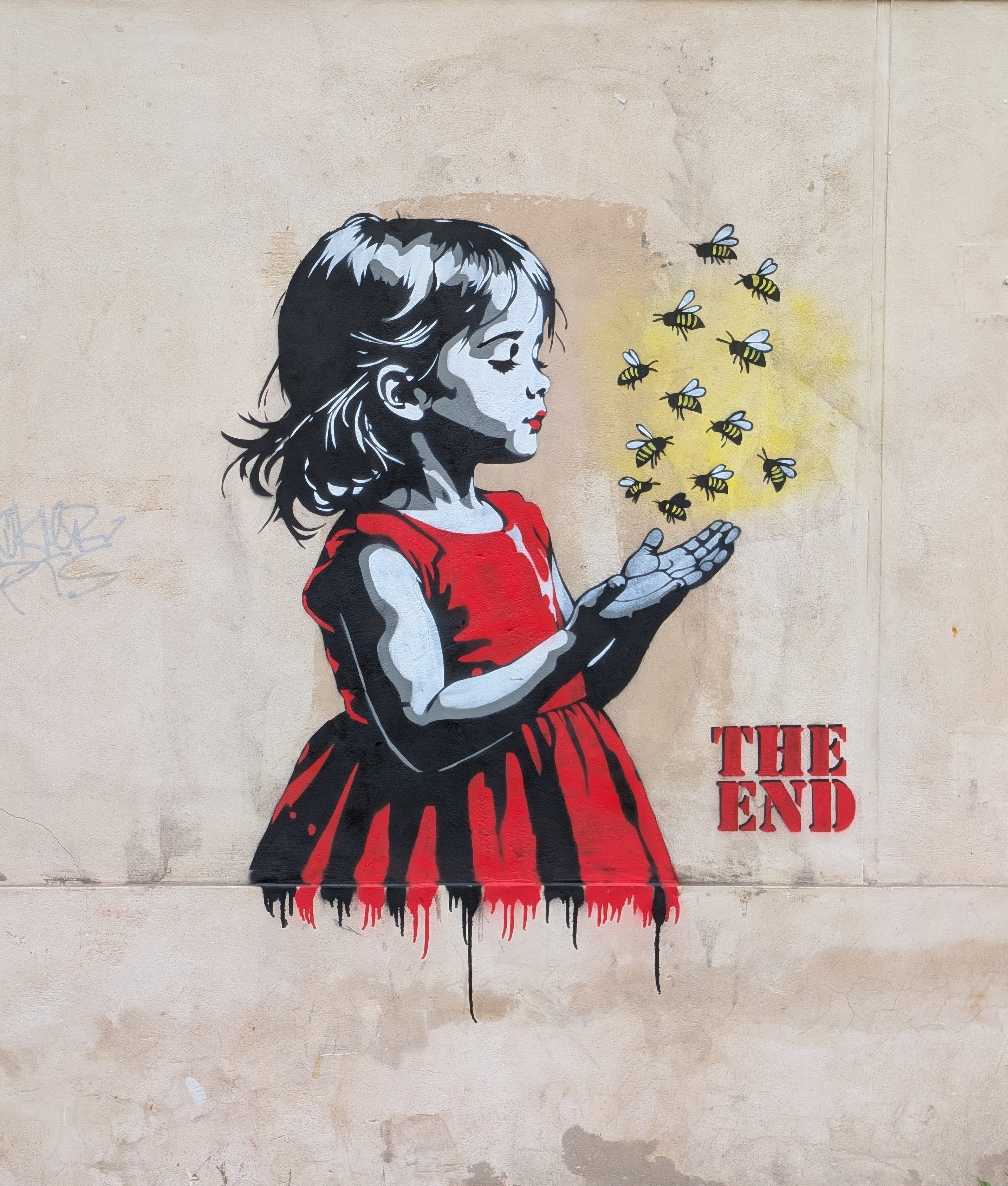 Street art: girl in red dress with bees