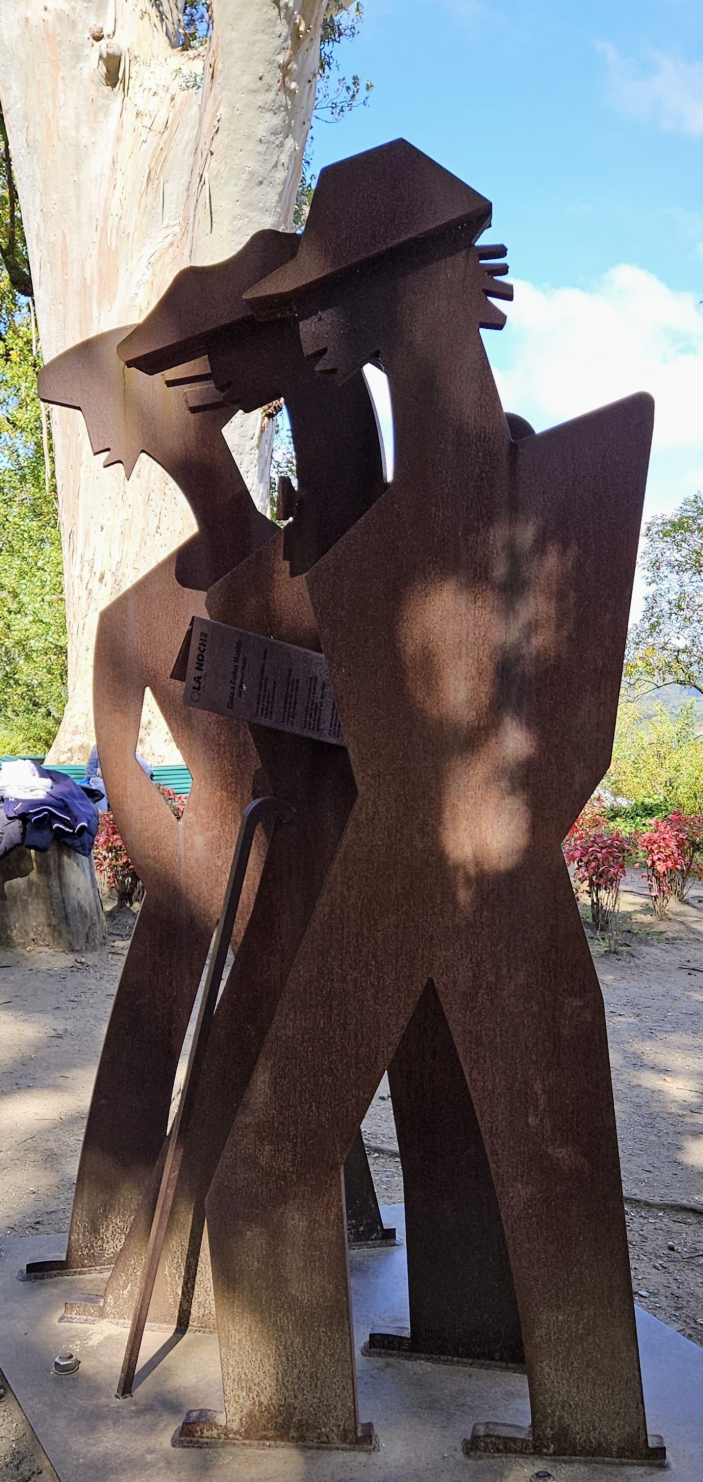 Flat metal sculpture of men walking, Alameda Park