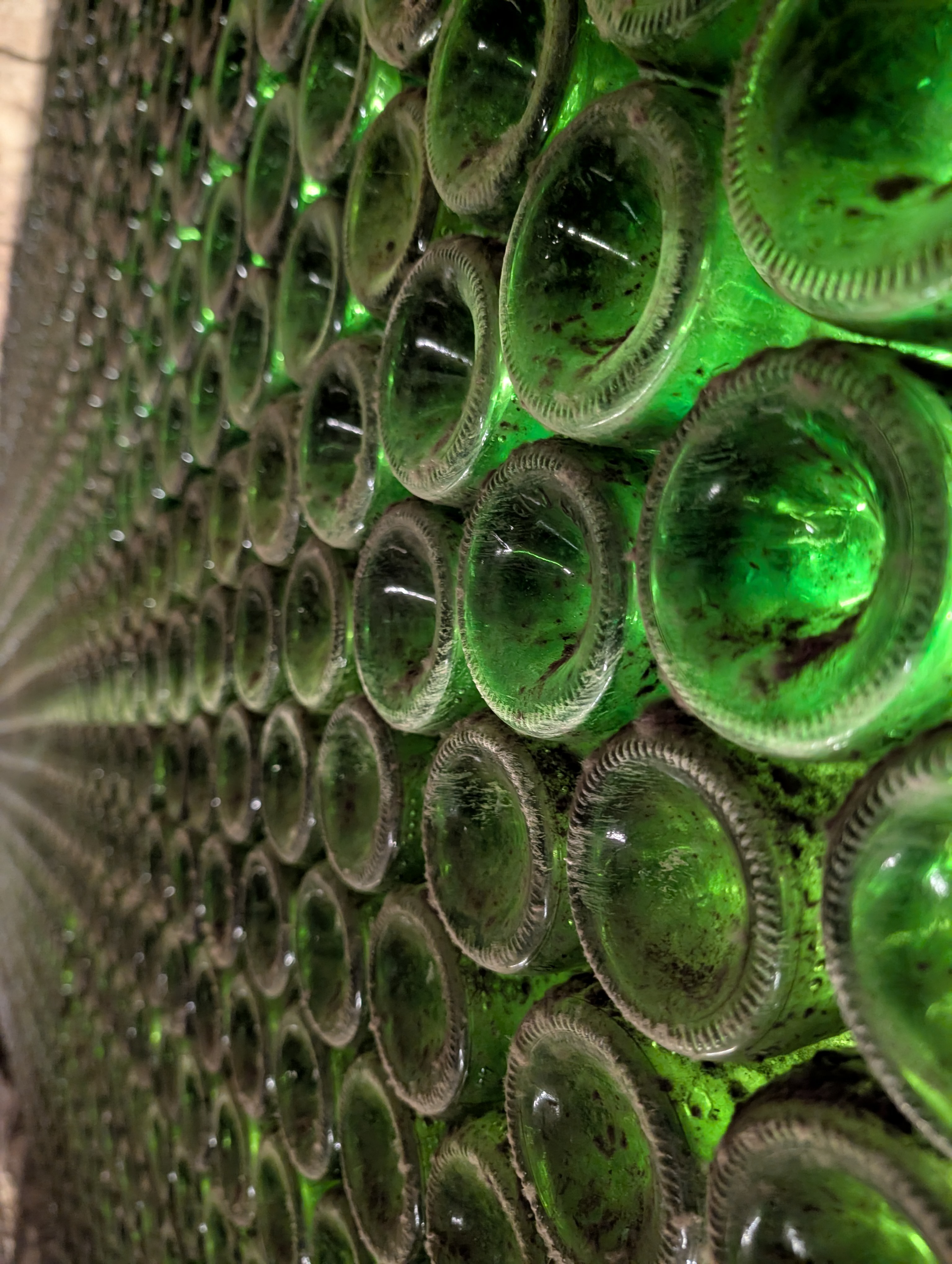 Stack of backlit green bottles at Bodegas Tritium