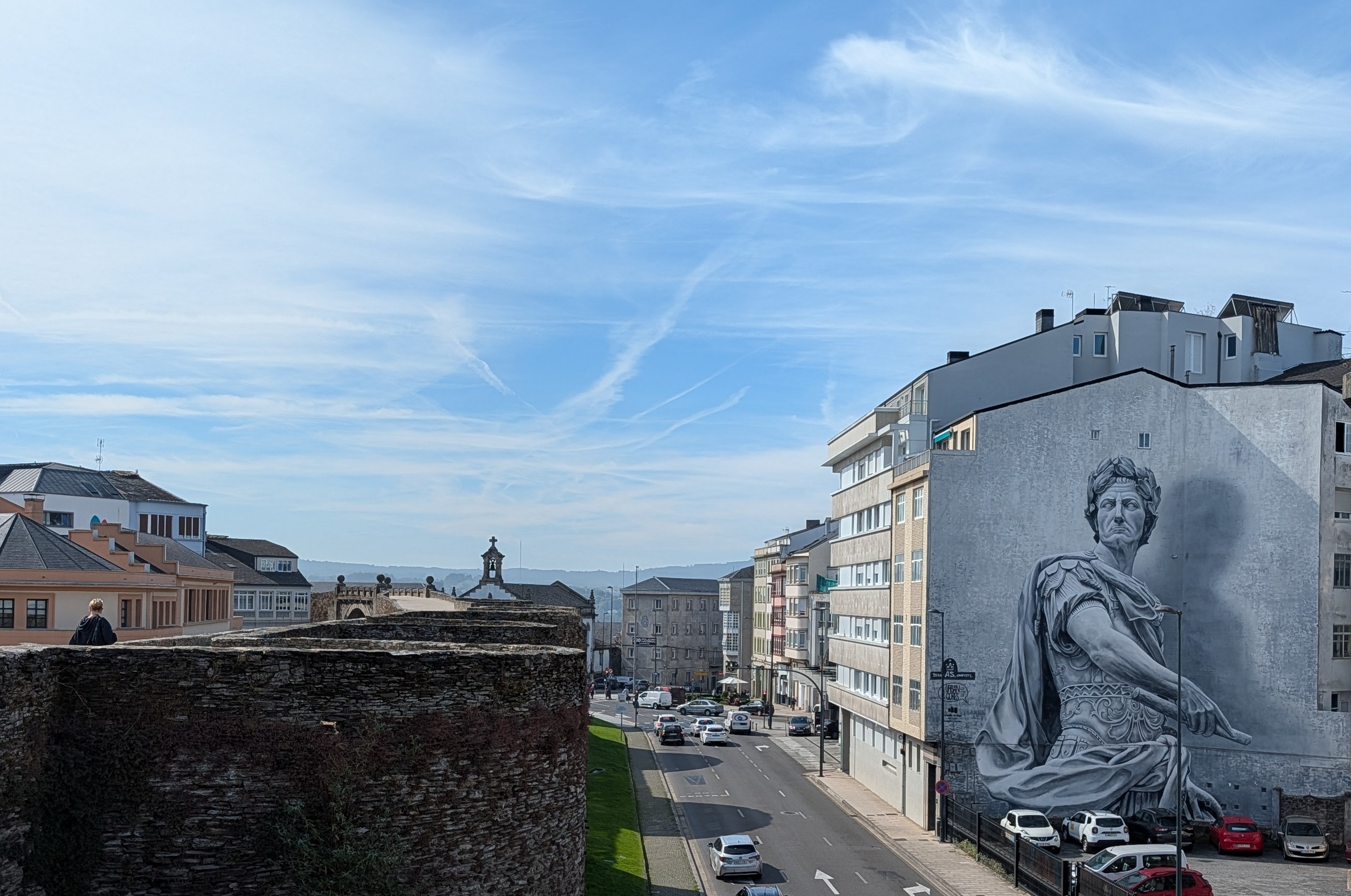 Mural of emperor seen from atop the Roman wall in Lugo