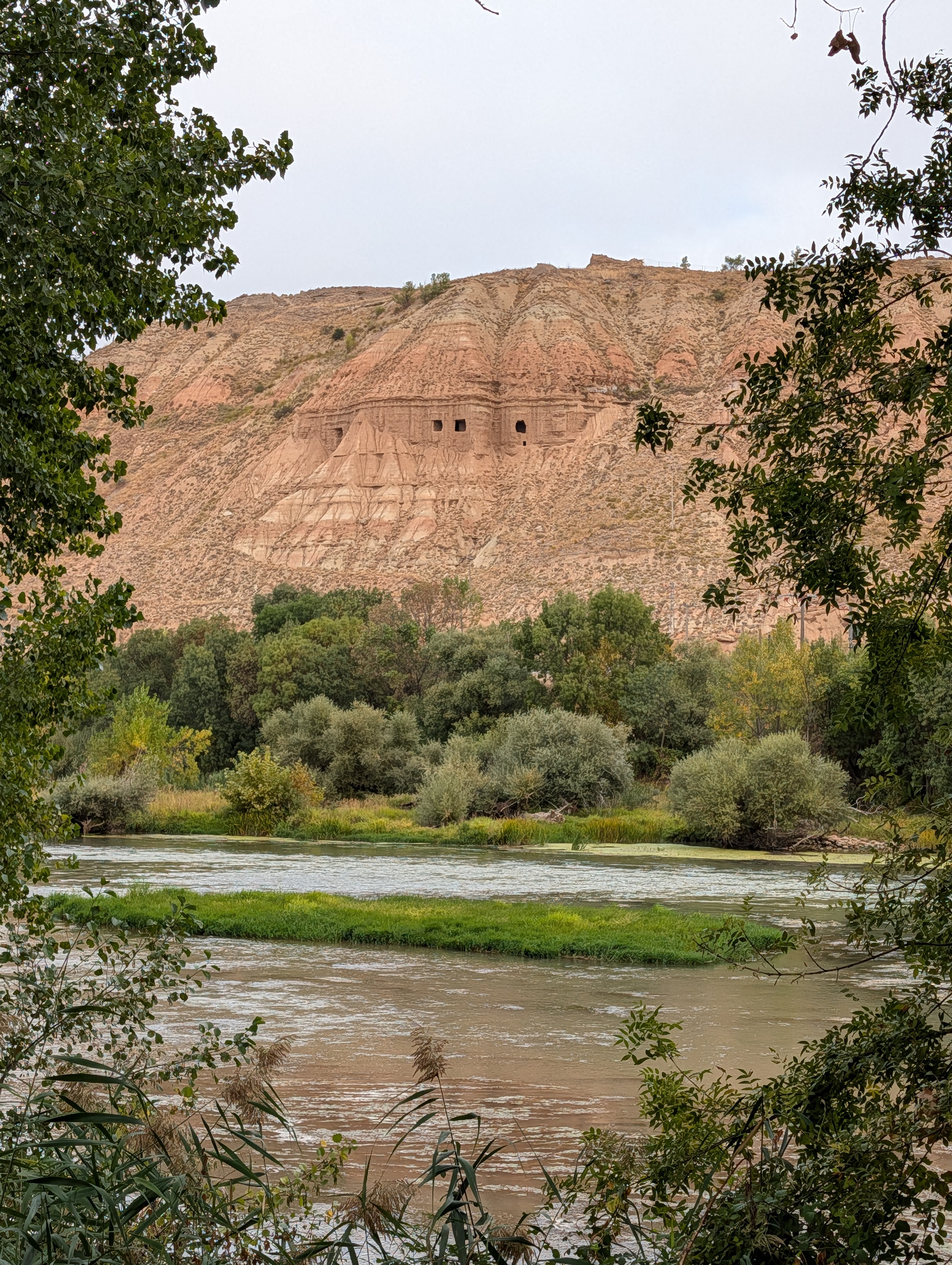 Caves are visible in the cliffs above the park