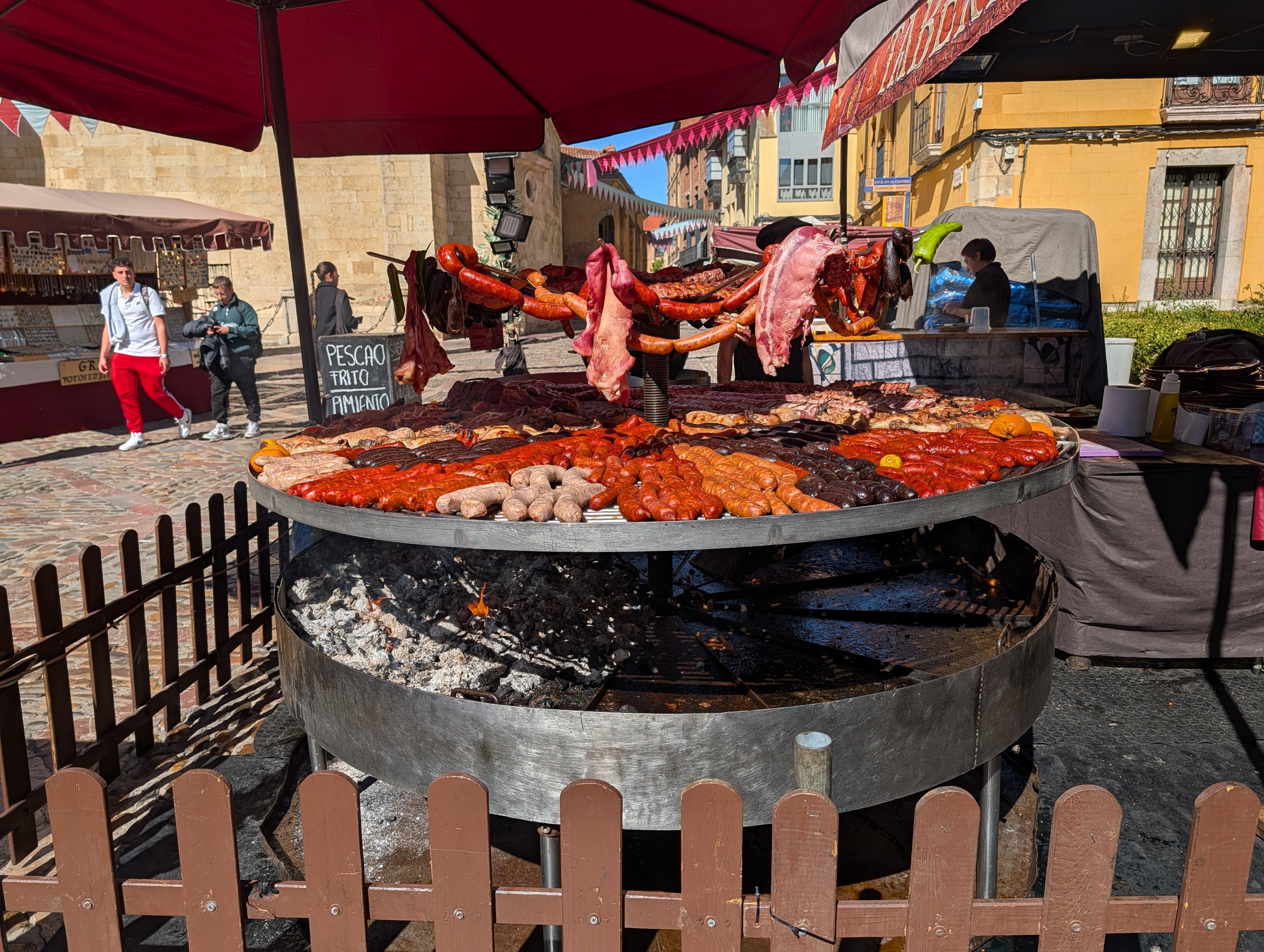 Giant circular grill with lots of different sausages and meats