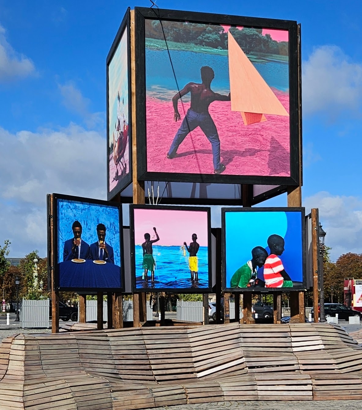 Photo display above free-form wooden benches