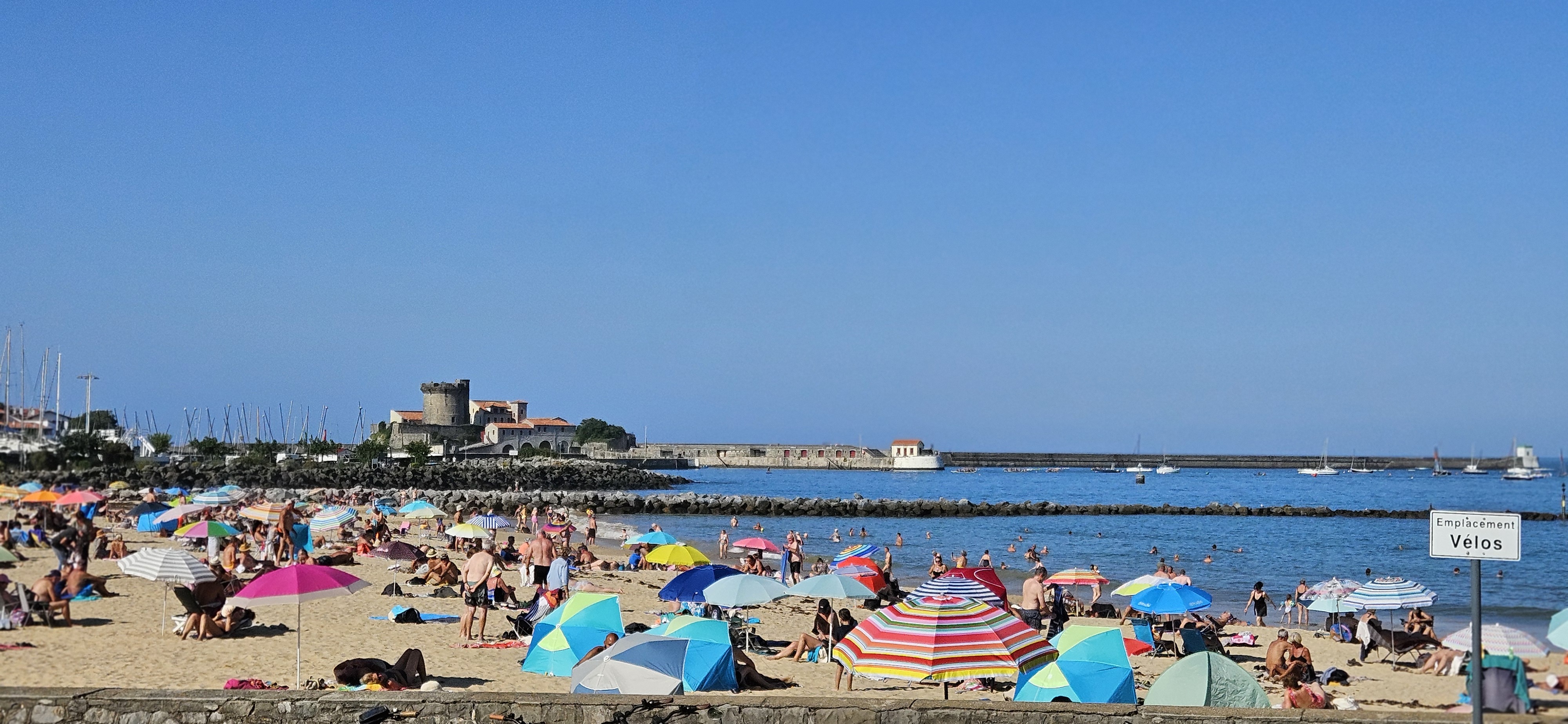 Crowded beach in front of Fort de Socoa, Ciboure, France