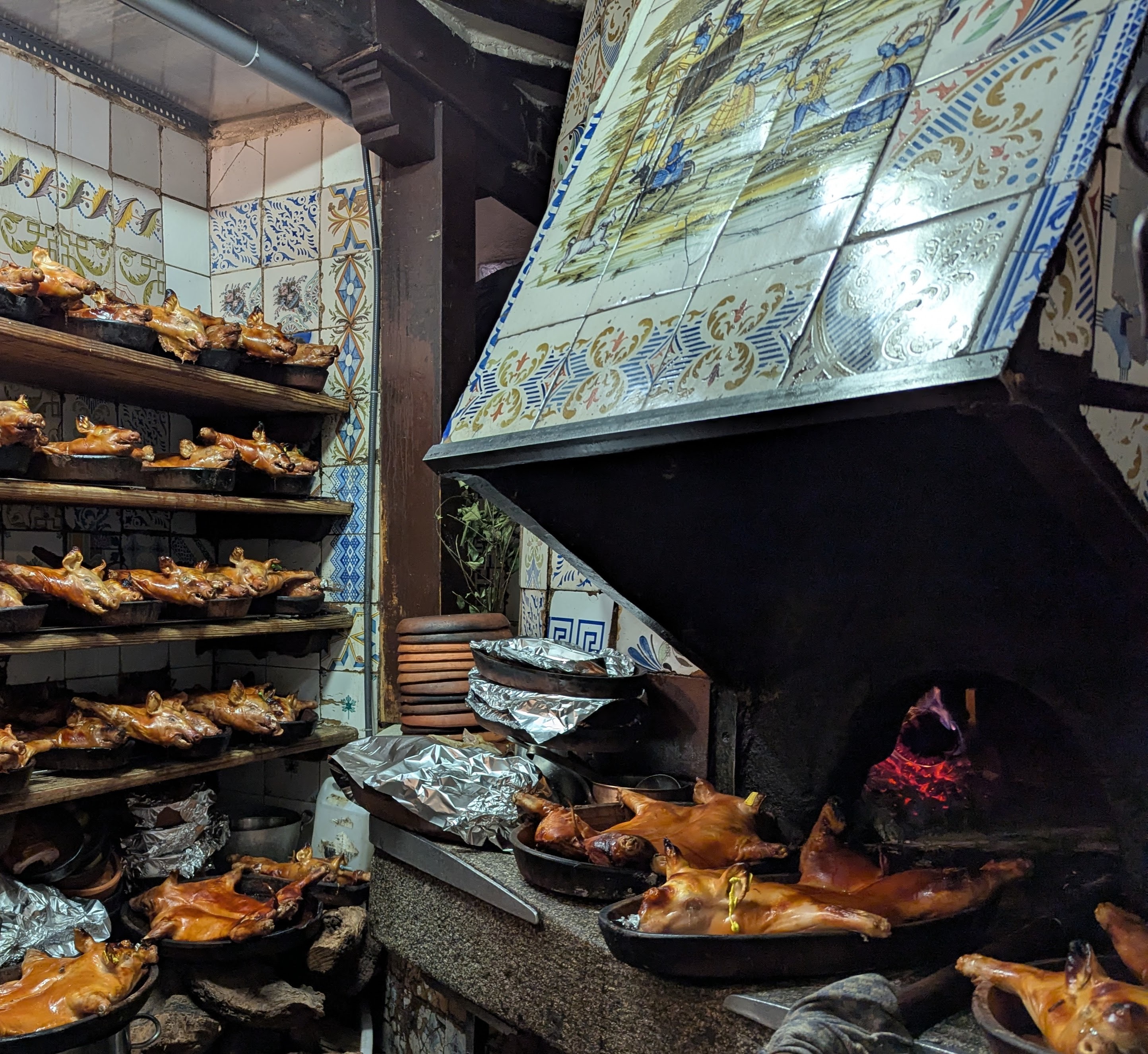 Botín's wood oven and some of the day's supply of suckling pigs