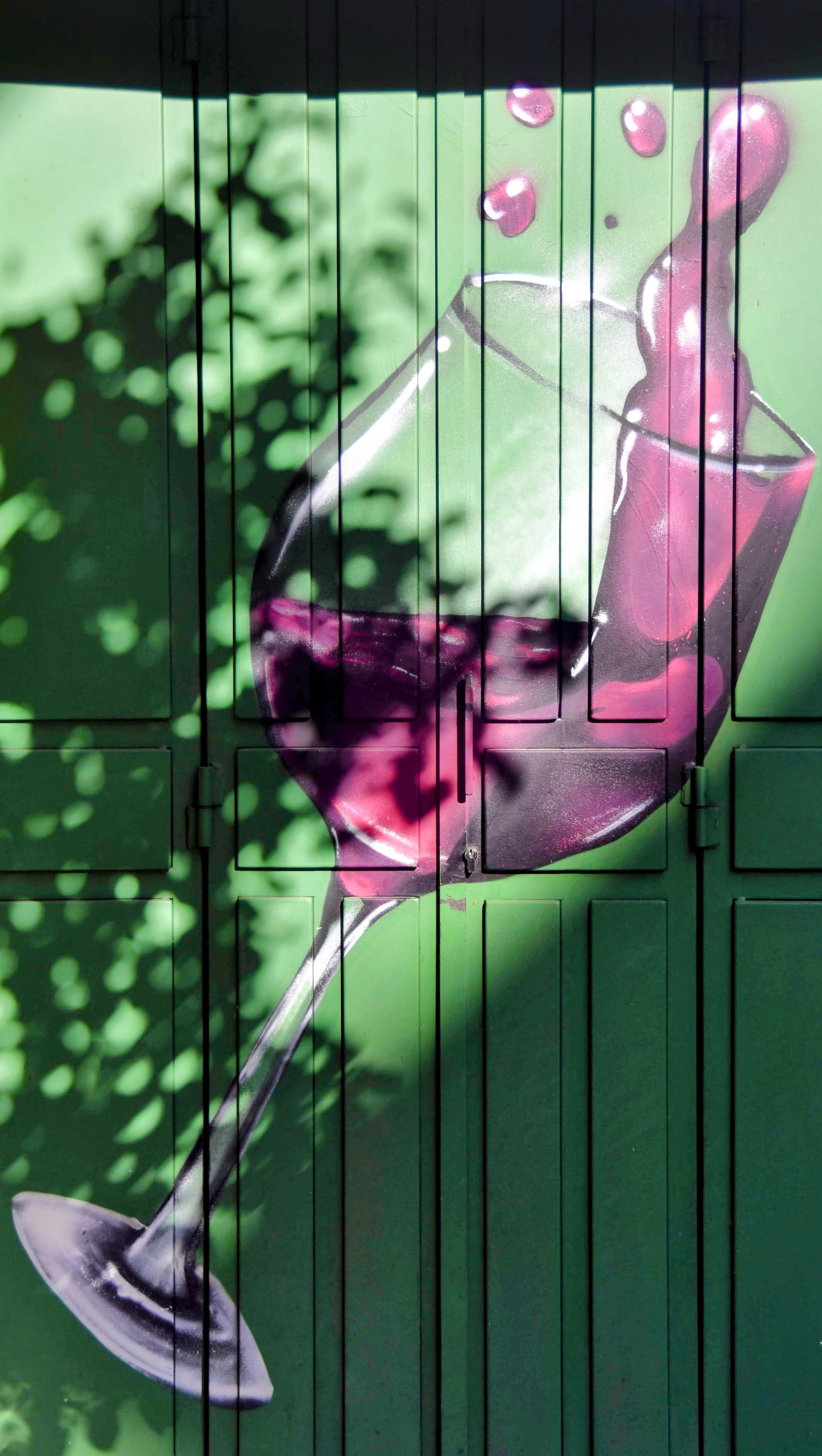 Wine glass mural on green wall, Madrid
