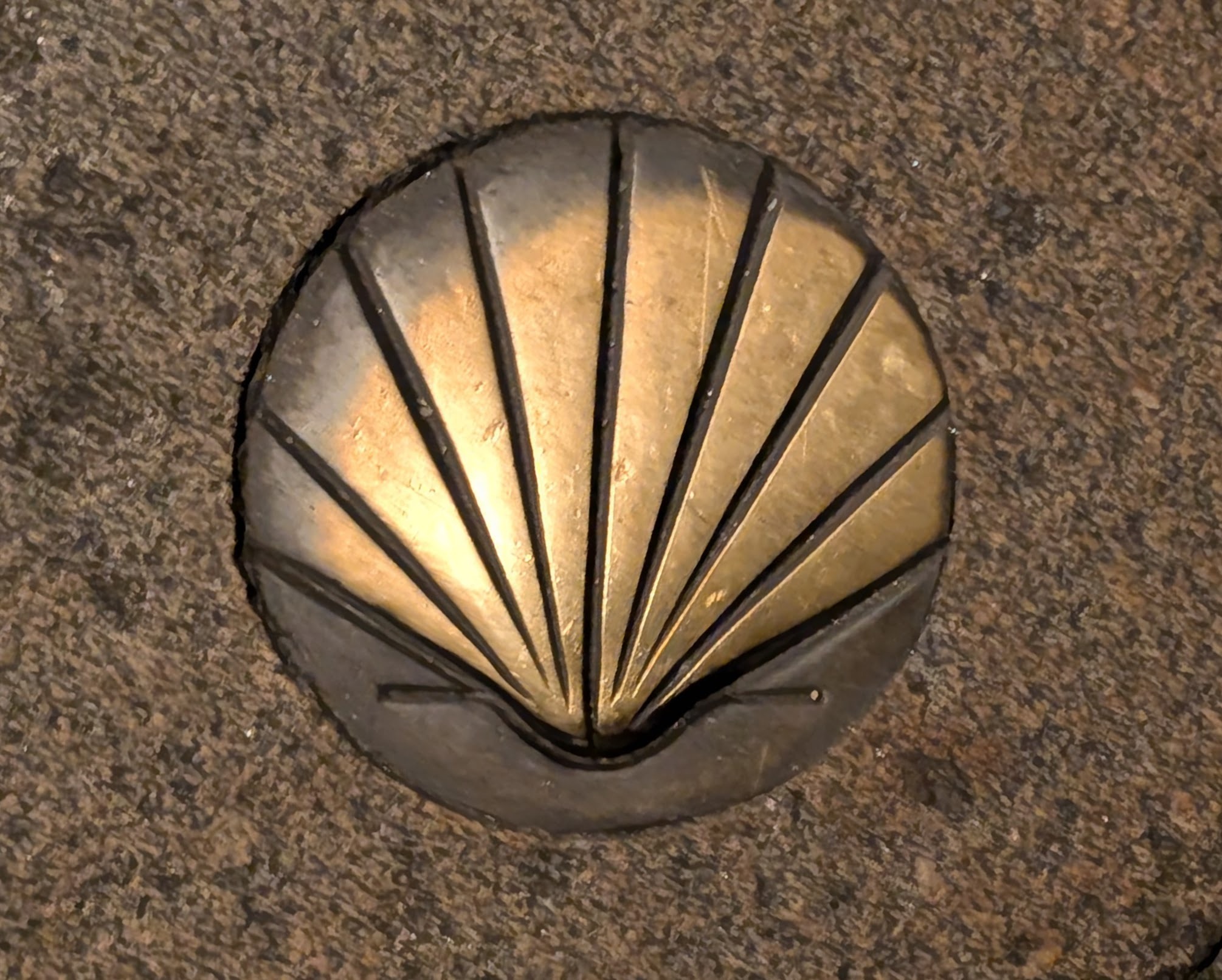 Brass scallop shell inset into wall