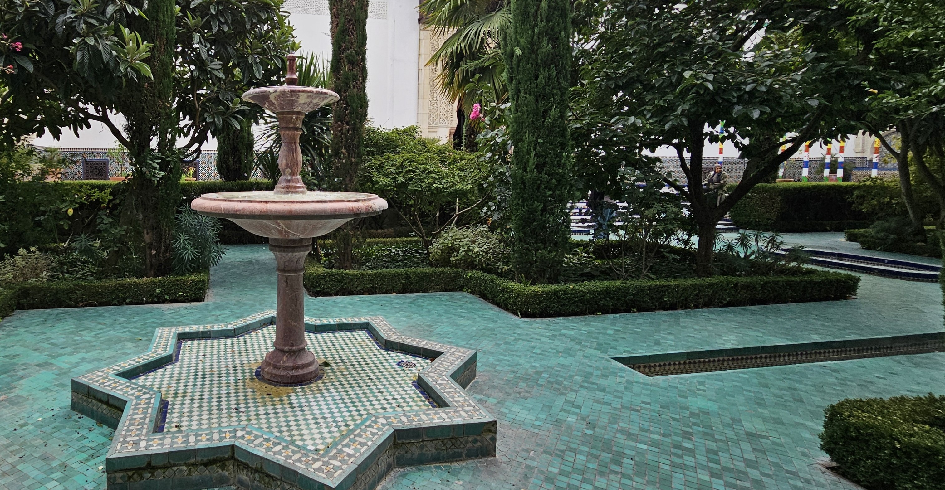 Outside garden with blue tiled court looks like one big pool