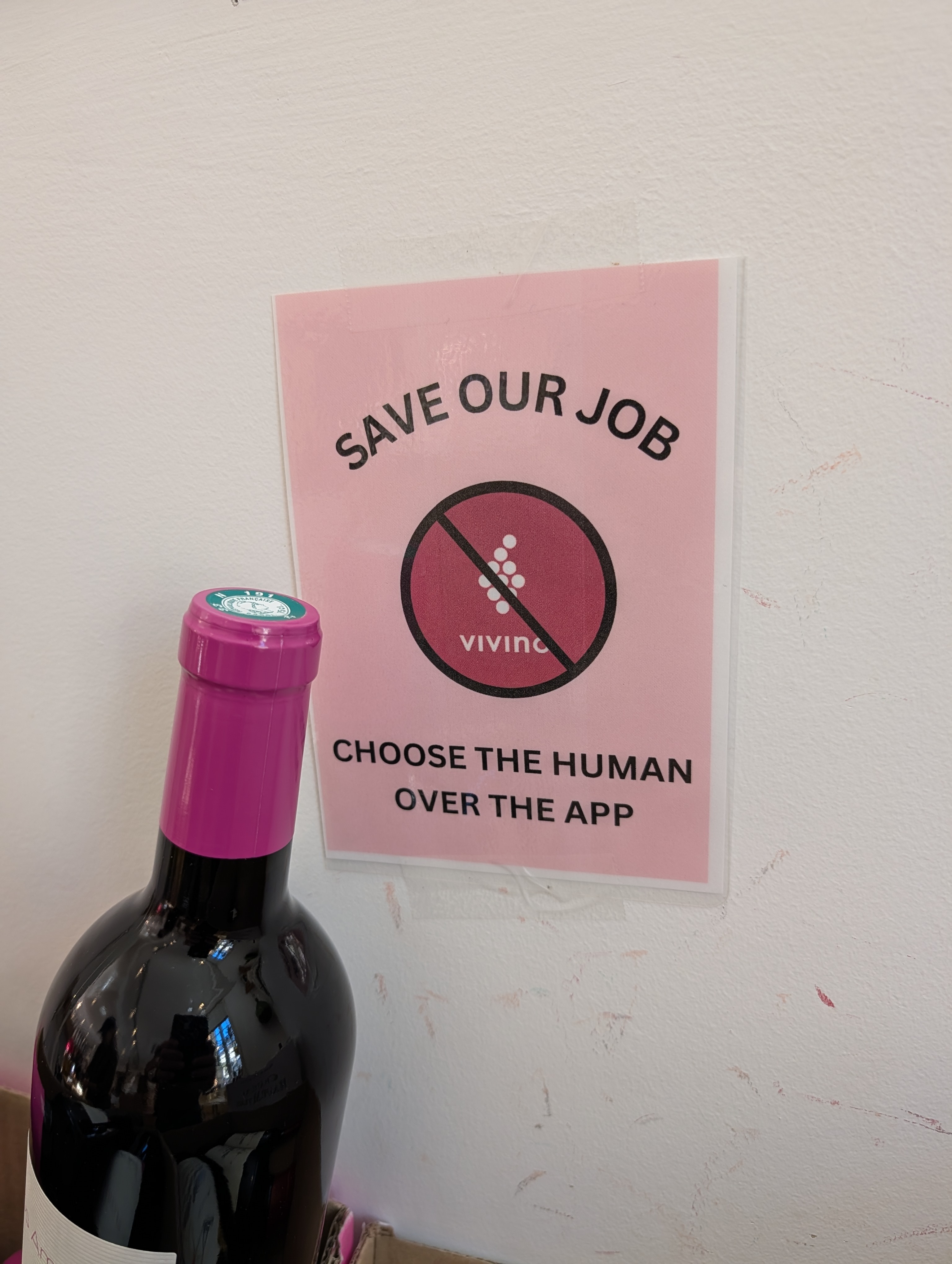 Sign encouraging people to ask about wines instead of using apps