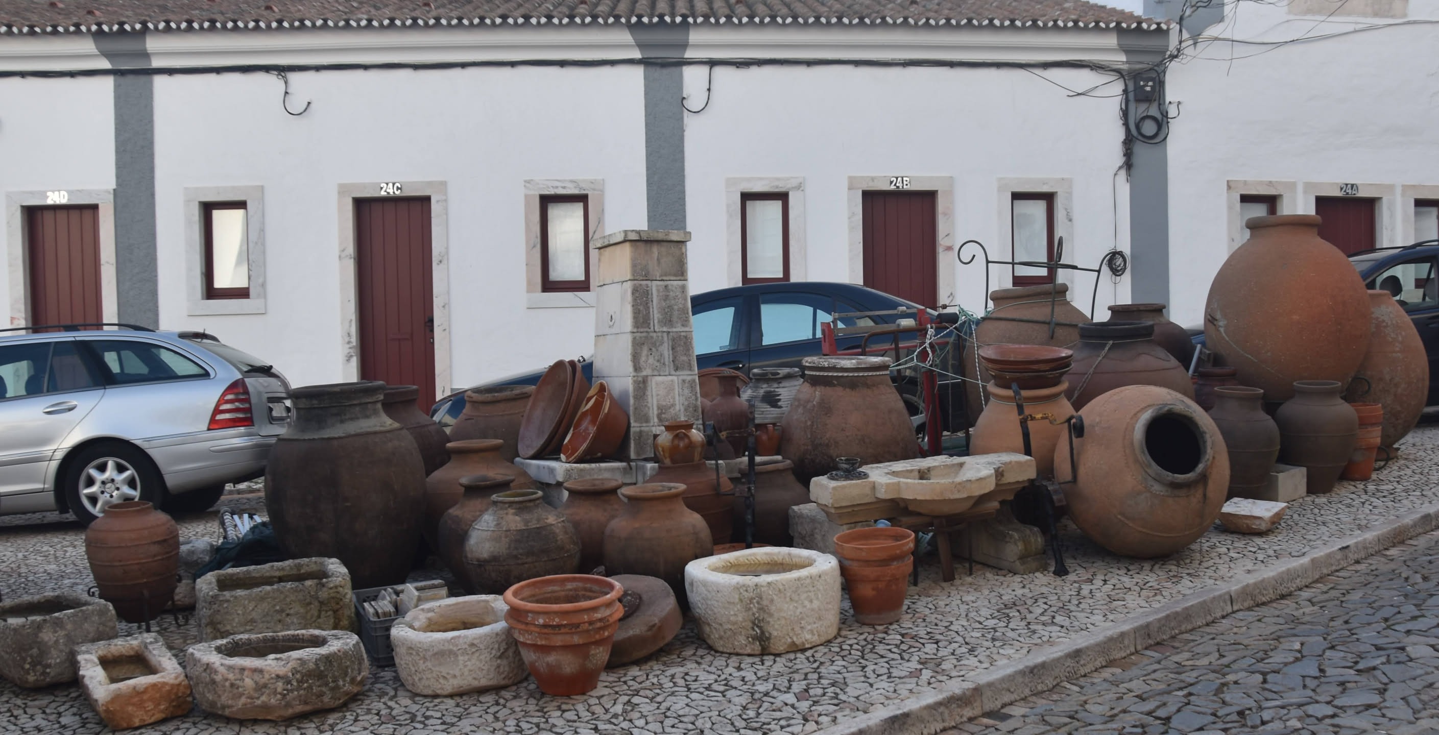 Display of water vessels around old public fountain