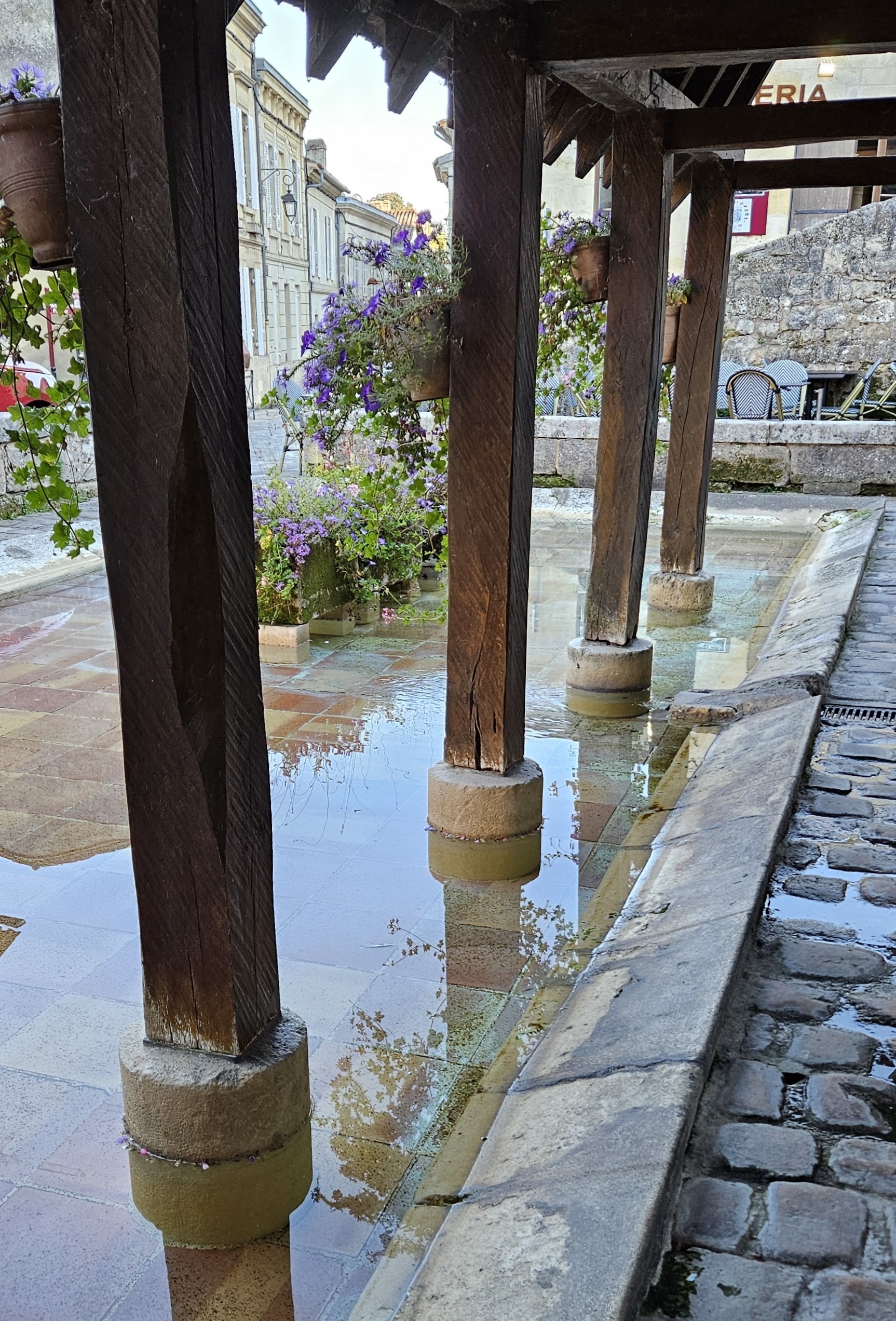 King's Fountain laundry washing pool with flower planters in the middle