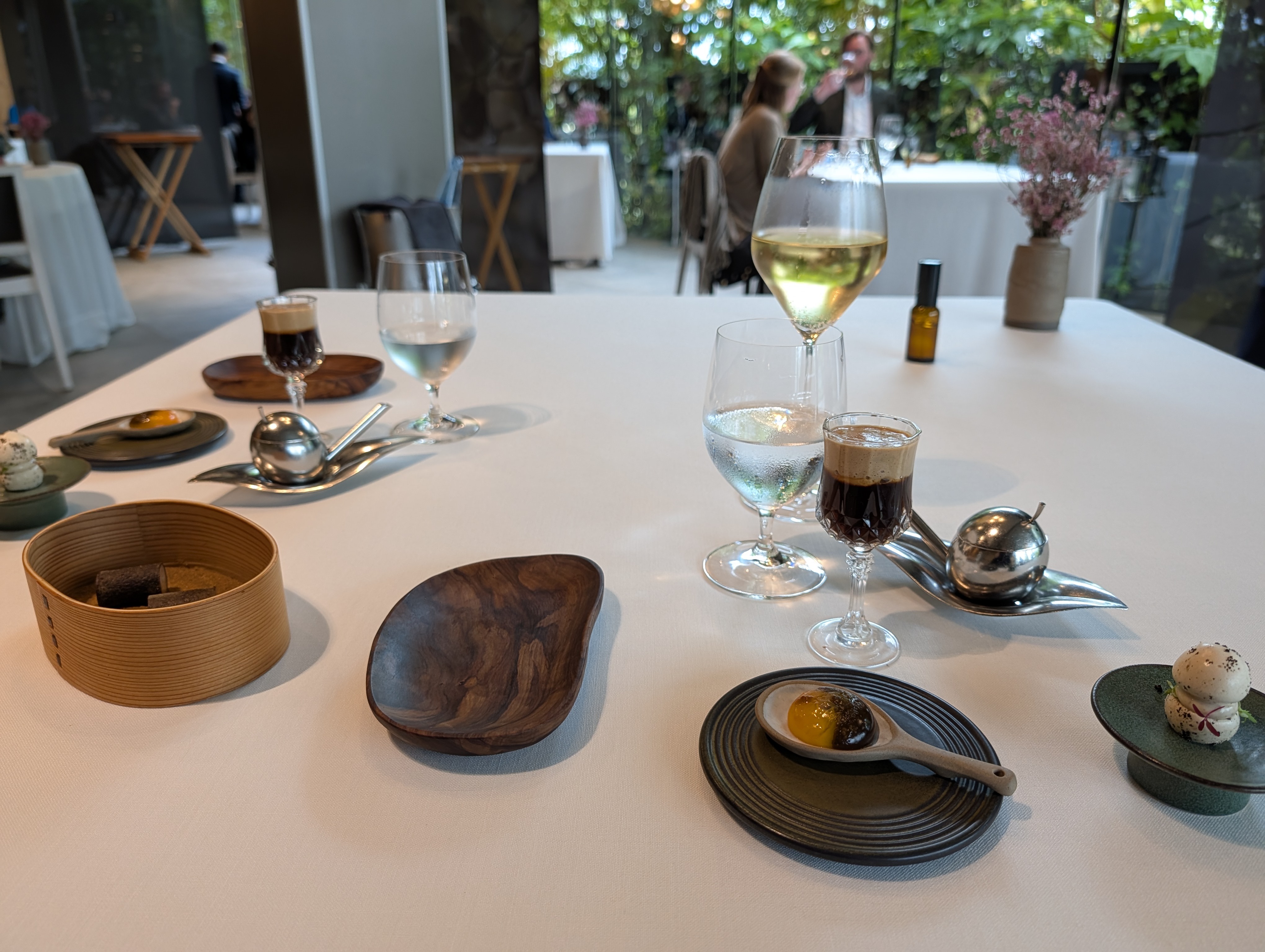 Small bites and mushroom broth in a glass