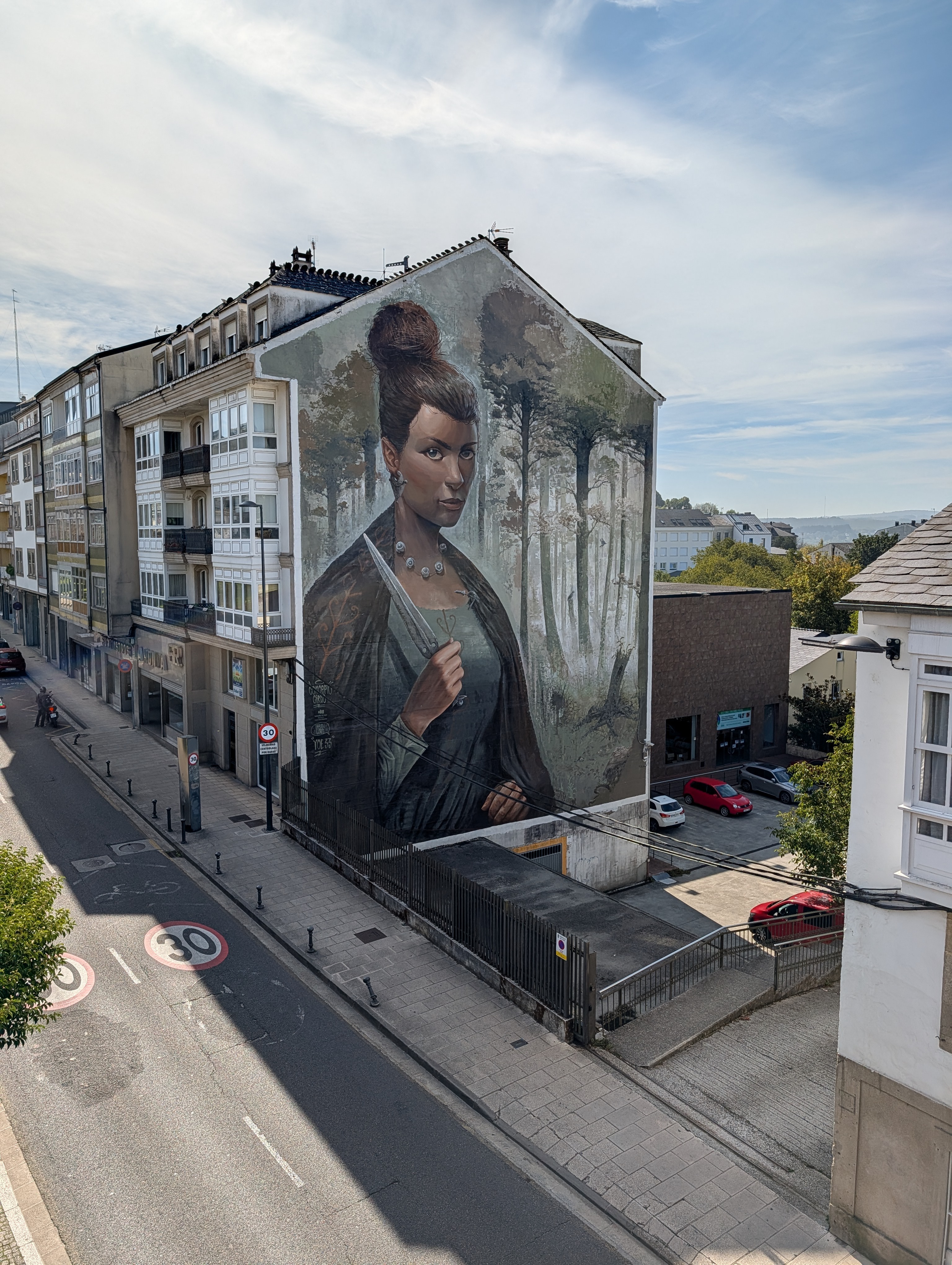 Mural of woman, maybe an elf, holding a knife, in Lugo